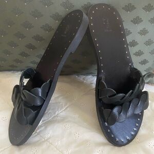 Frye Black Azalea slide sandal. Braided, leather upper. Leather lining.